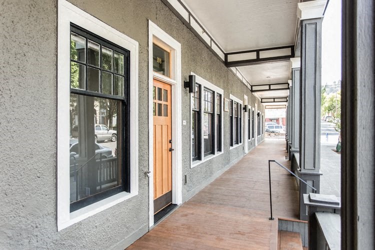 a long hallway with doors and windows on a building