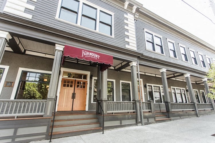 the front of a building with a red sign on it