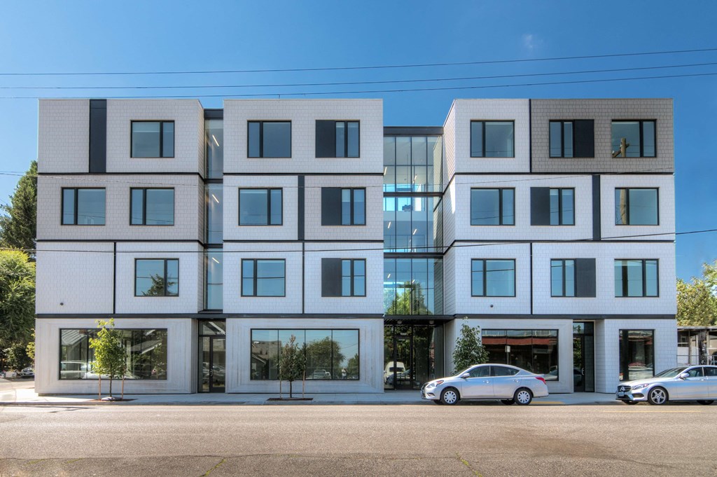 the facade of a building with cars parked in front of it