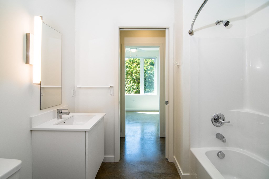a bathroom with a sink and a tub and a shower