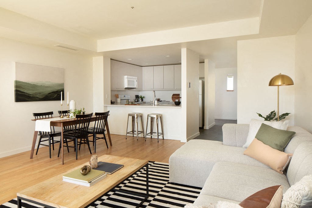 a living room and kitchen with a couch and a table