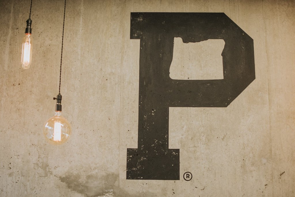 a letter f painted on a wall next to a light bulb