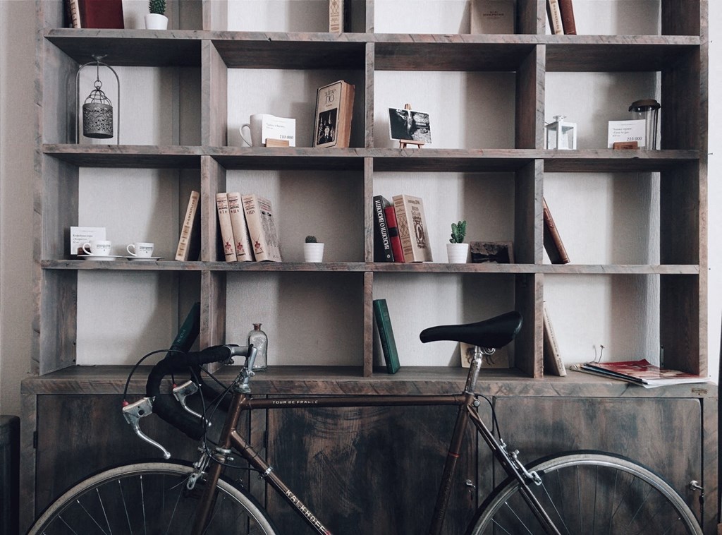 a bike parked in front of a book shelf