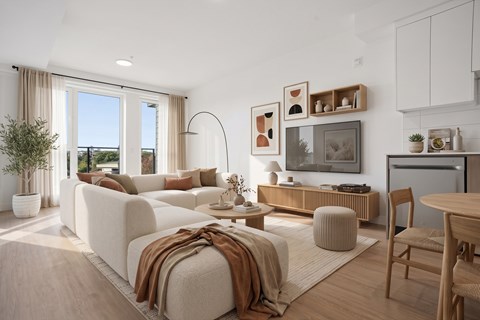 A modern living room with a white sofa and wooden furniture.