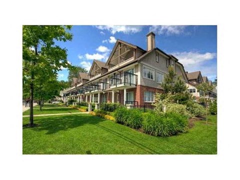 A large house with a lawn in front.