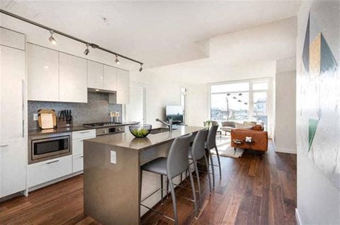 A modern kitchen with a dining table and chairs.