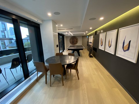 A conference room with a table and chairs.