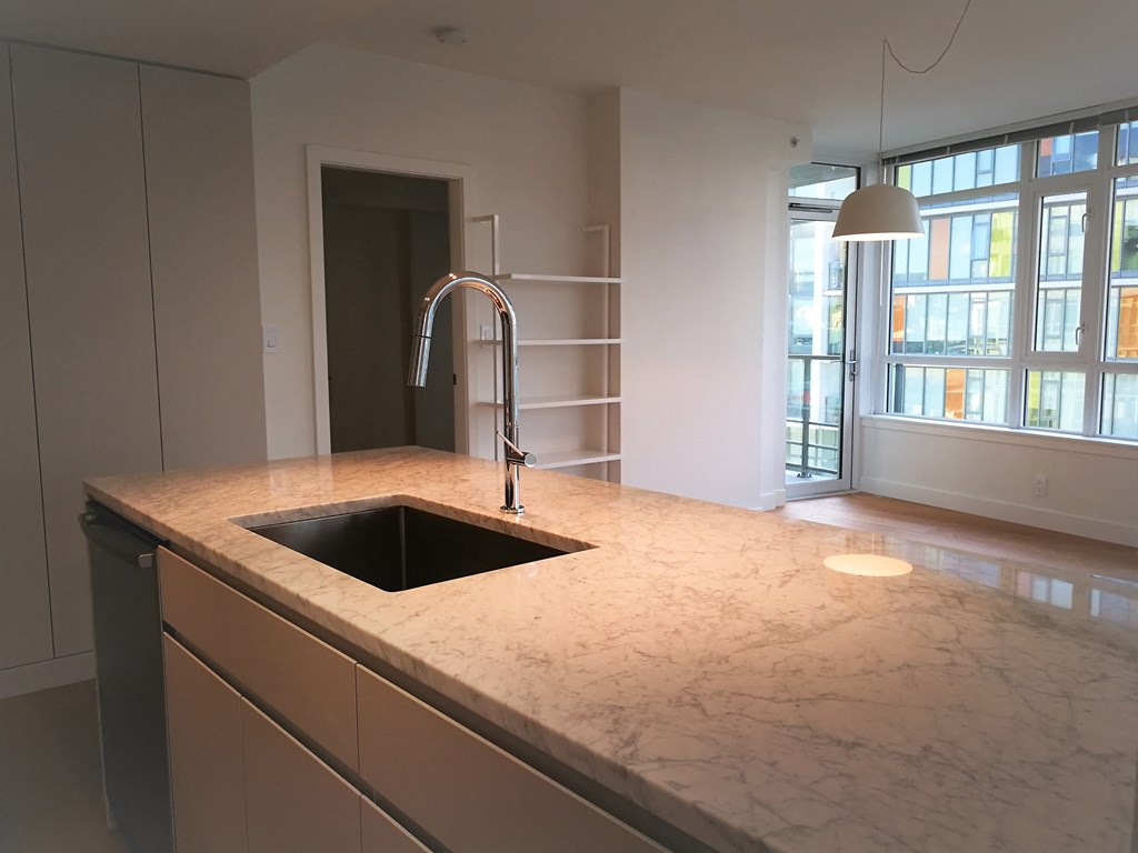 a kitchen with marble counter tops and a sink