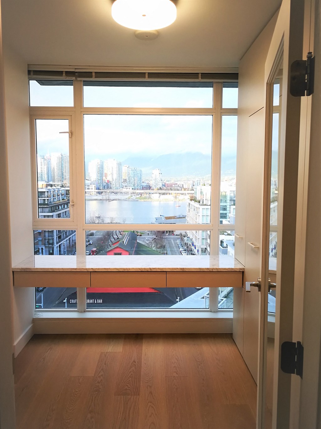 a view of the city from the window of a room in a building