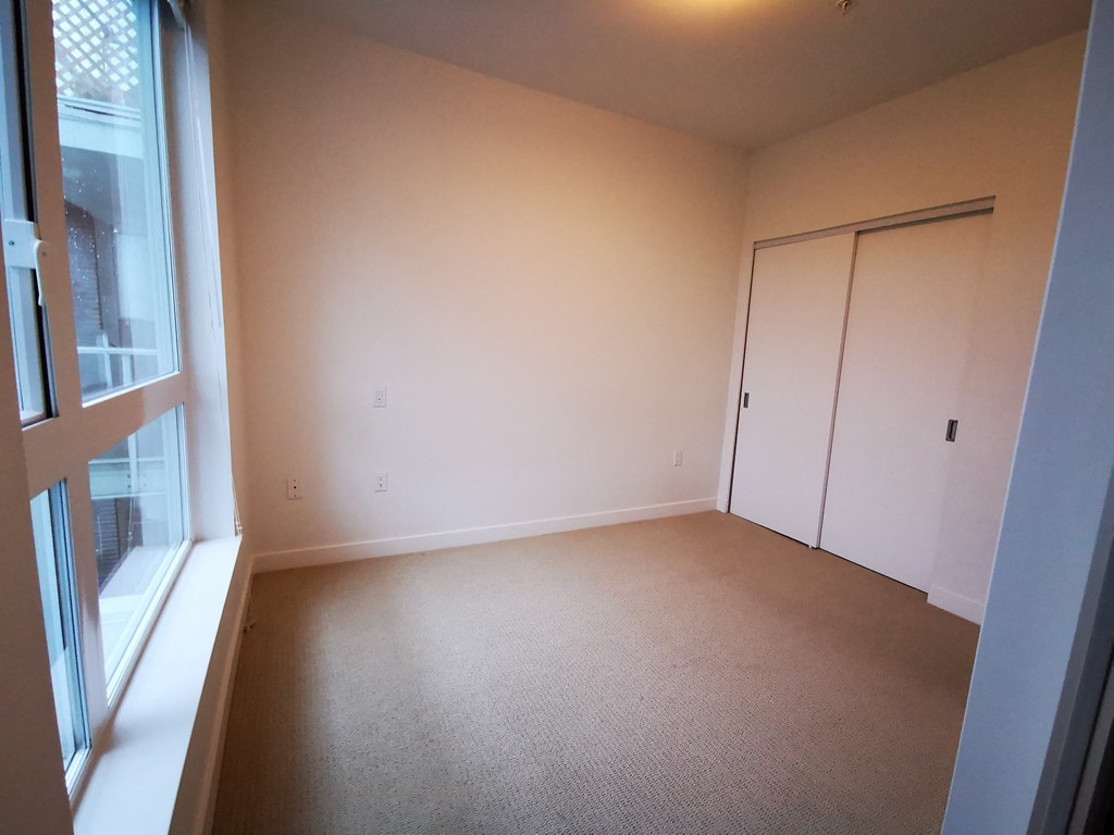 an empty room with a window and a door