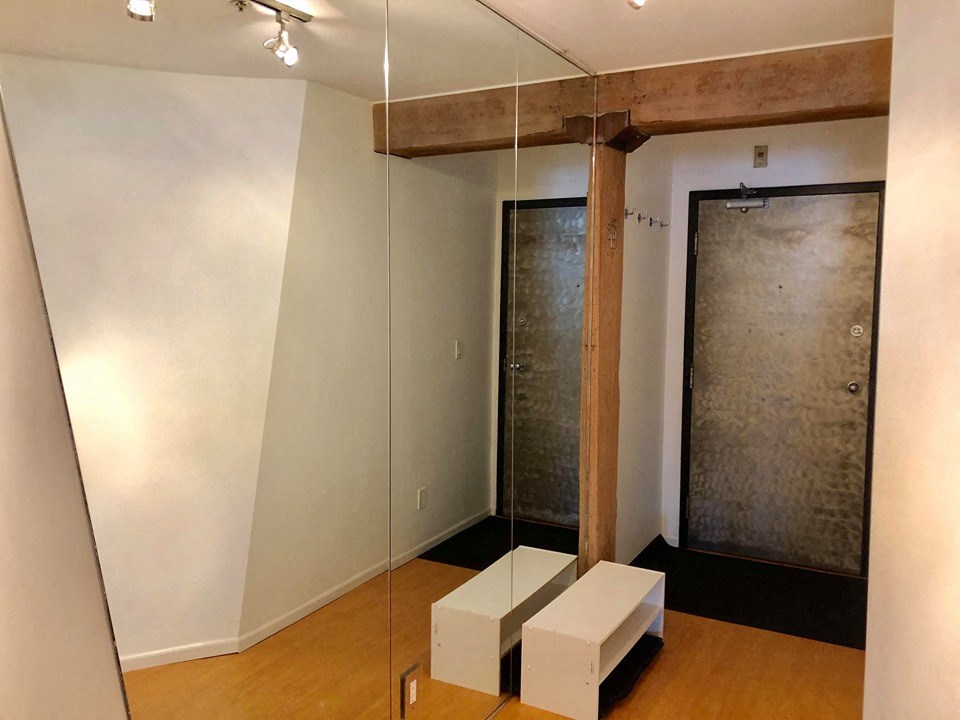 a room with a mirror and some white cubes on the floor