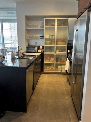 a kitchen with a large refrigerator freezer next to a window