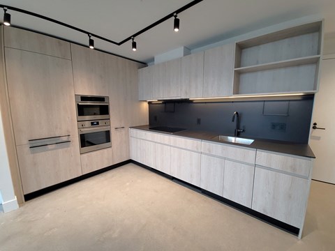 a modern kitchen with white cabinets and a sink