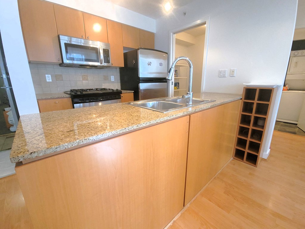 a kitchen with a granite counter top and a sink