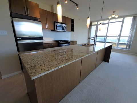 a view of a kitchen with a granite counter top