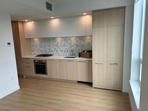 a kitchen with wooden cabinets and a stove and a sink