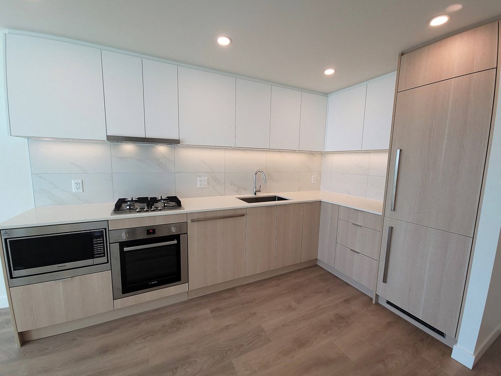 a kitchen with white cabinets and stainless steel appliances