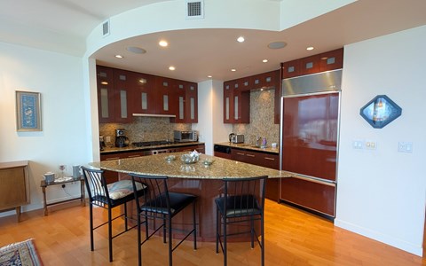 A kitchen with a table and chairs in the middle of it.