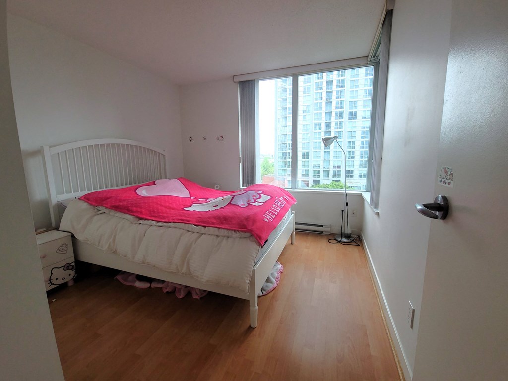 a bedroom with a bed and a window