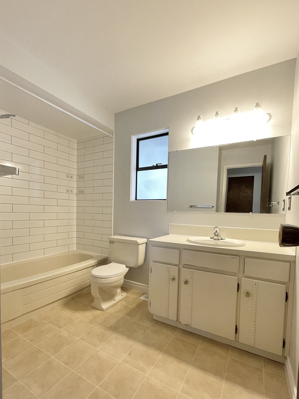 a bathroom with a toilet and a sink and a bath tub