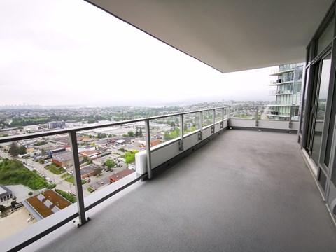A balcony with a view of a cityscape.