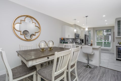 a dining room and kitchen with a table and chairs