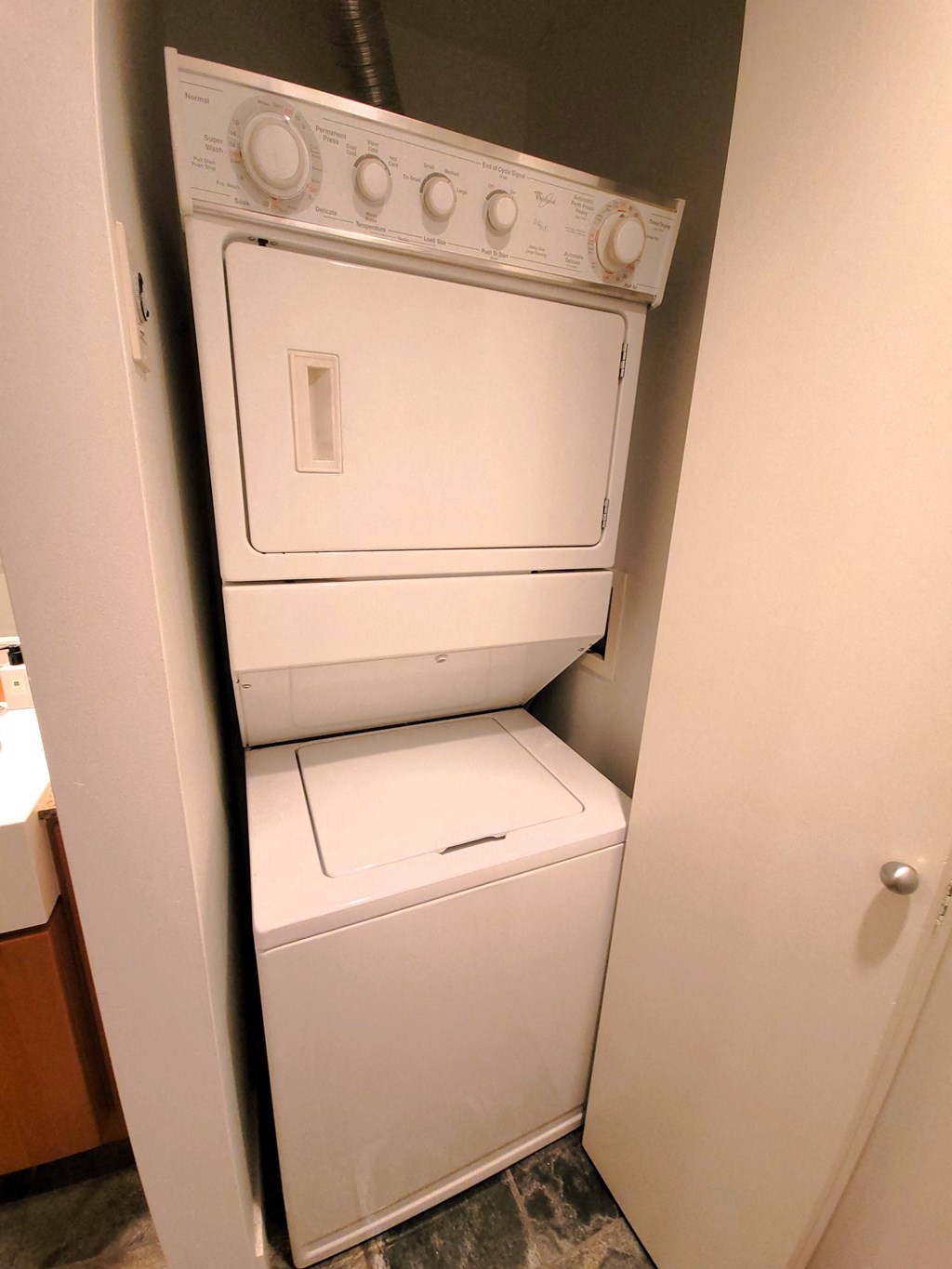 a washer and dryer in a kitchen with a door