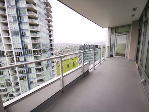 A balcony with a view of a cityscape.
