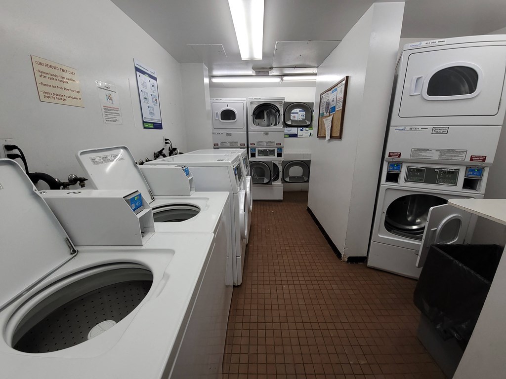 a laundry room with washers and dryers