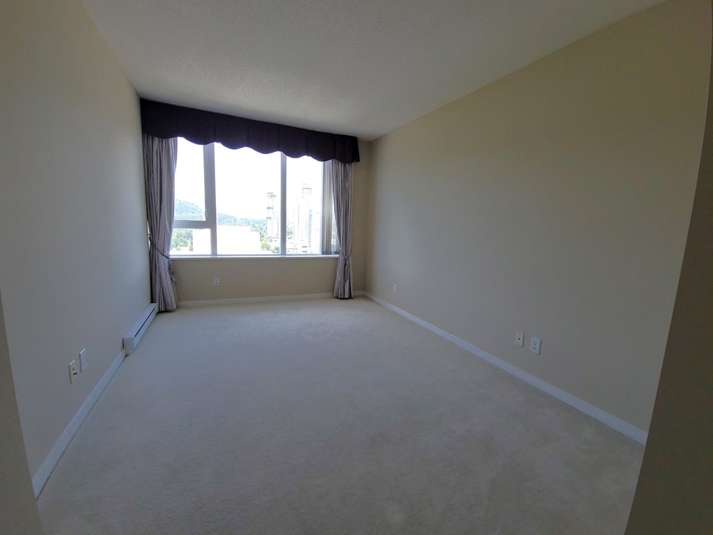an empty living room with a large window