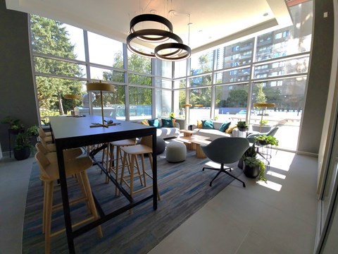 A modern dining room with a large table and chairs.