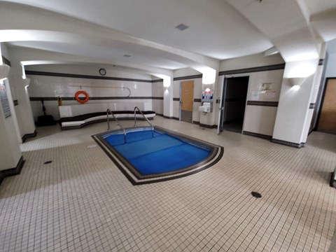 a pool in the middle of a room in a large hall