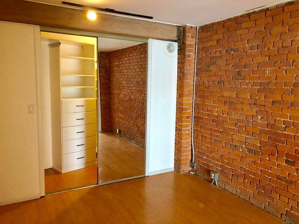 a brick wall in a room with a mirror