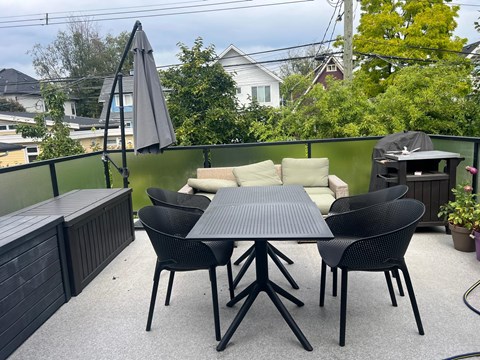 A patio with a table and chairs.