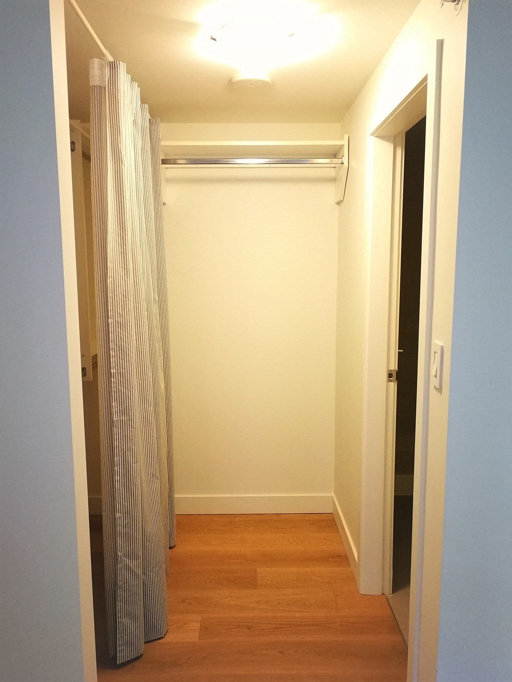 a room with a closet and a curtain