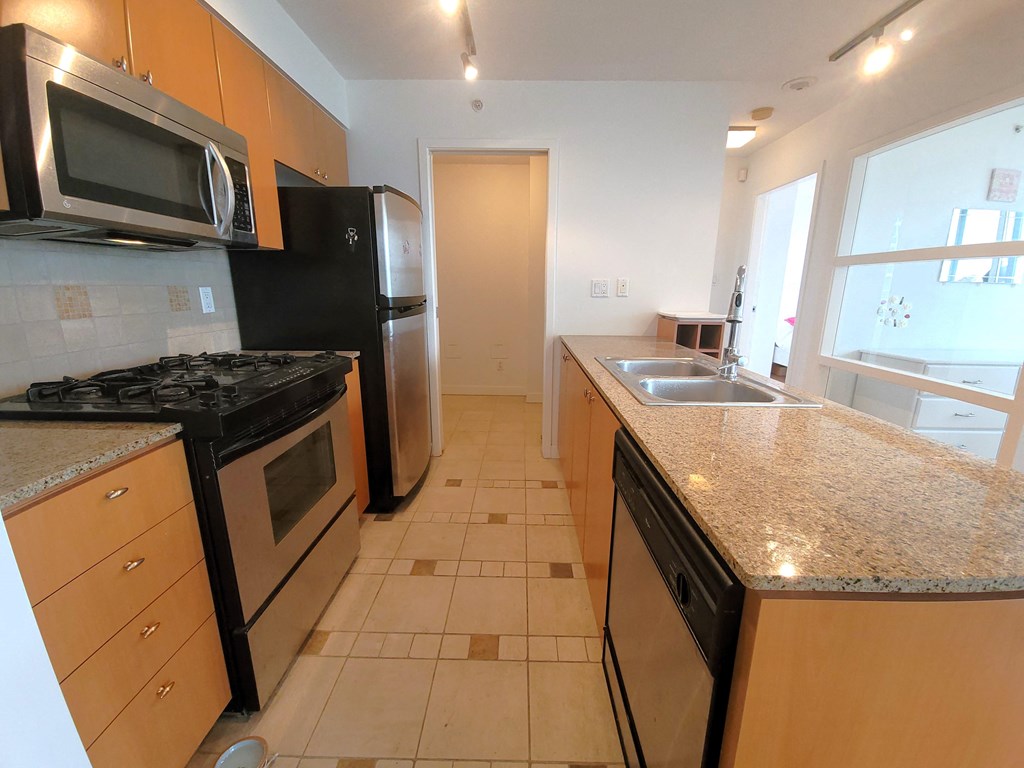 full kitchen with granite counter tops and stainless steel appliances