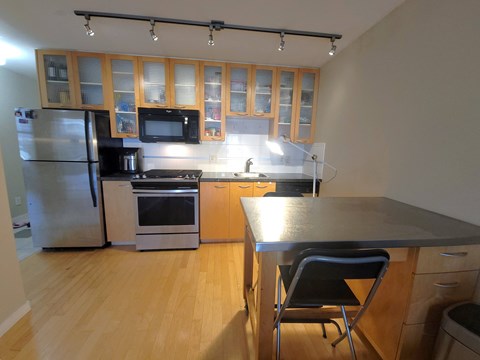 a kitchen with stainless steel appliances and wooden cabinets
