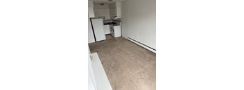 A small, empty room with a washer and dryer.