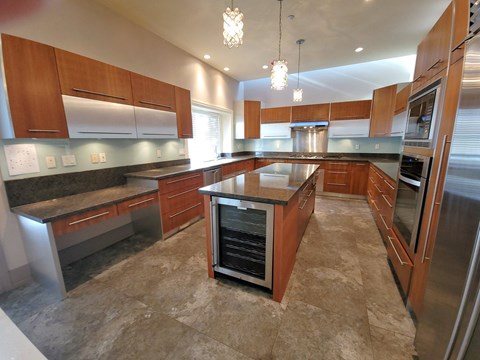 A kitchen with wooden cabinets and a central island.
