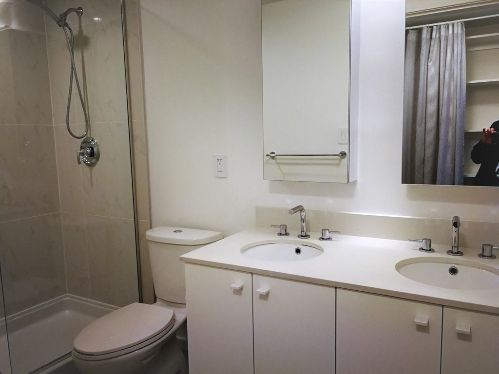 a bathroom with a sink toilet and a shower