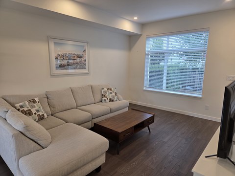 A living room with a large couch and a coffee table.