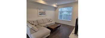 A living room with a large couch and a coffee table.