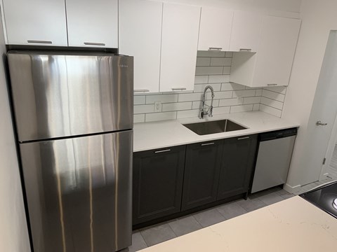a kitchen with a sink and a refrigerator