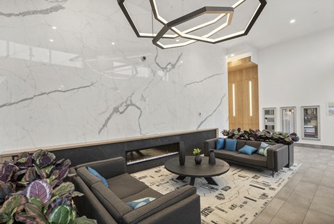 A modern living room with a grey sofa and a round coffee table.
