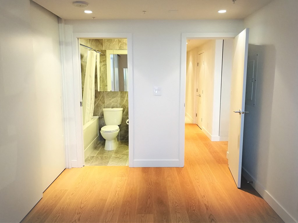 a view of a bathroom from a hallway with a toilet