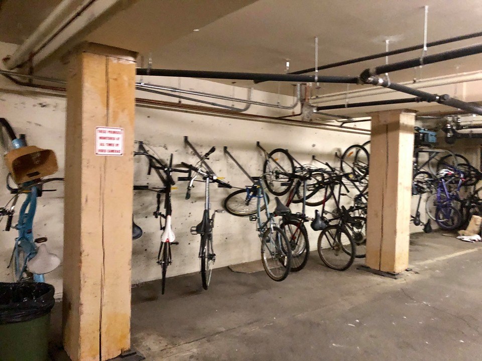 a parking garage with bikes on the wall