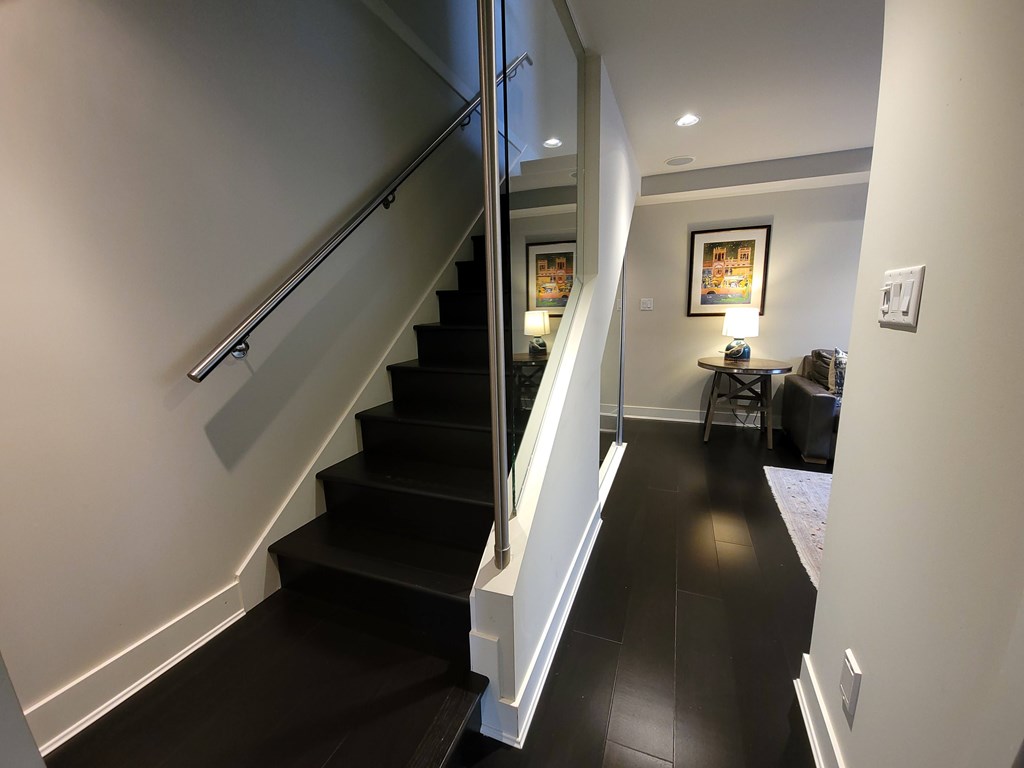 A staircase with a black tread and white risers.