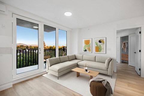 A living room with a couch, a coffee table, and a painting on the wall.