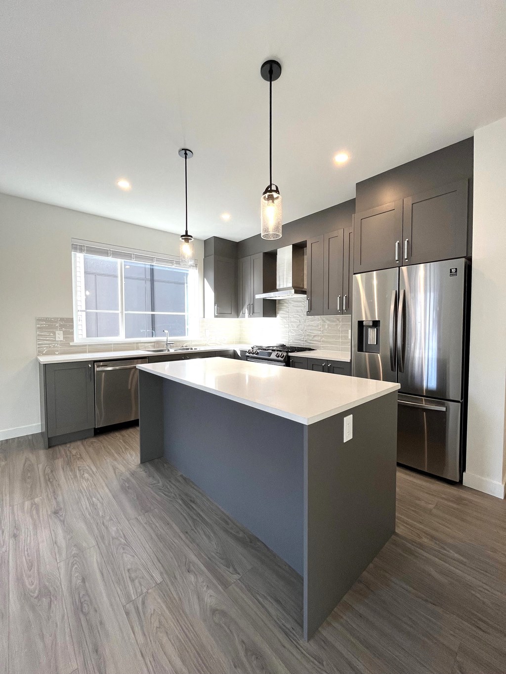 a modern kitchen with stainless steel appliances and a large island