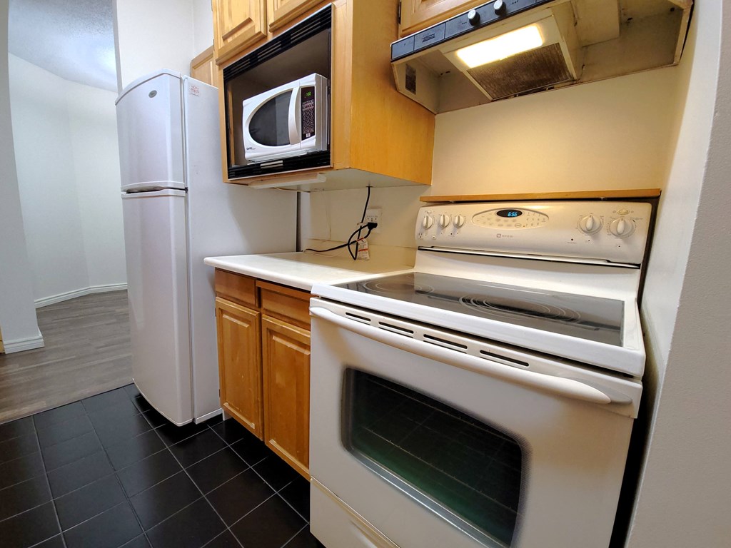 a kitchen with a stove microwave and refrigerator